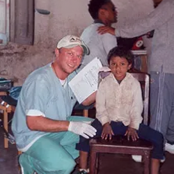 Chiropractor Russell Davis with a child.