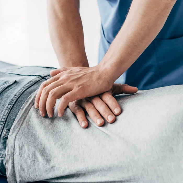 Chiropractor performing a chiropractic adjustment on a patient.